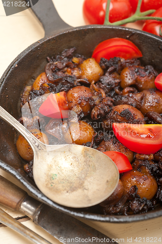 Image of Baby cuttle fish roasted on iron skillet