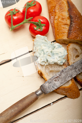 Image of fresh blue cheese spread ove french baguette