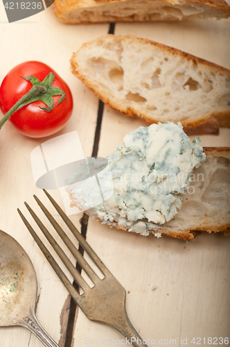 Image of fresh blue cheese spread ove french baguette