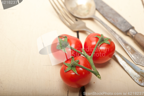 Image of ripe cherry tomatoes over white wood