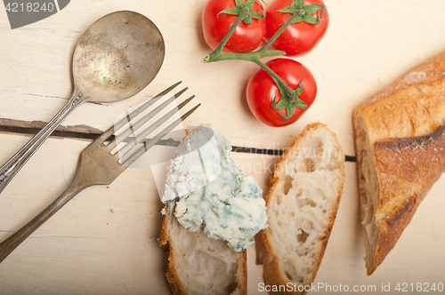 Image of fresh blue cheese spread ove french baguette