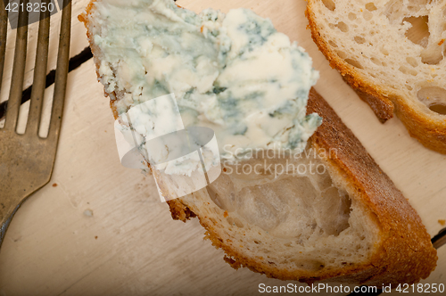 Image of fresh blue cheese spread ove french baguette