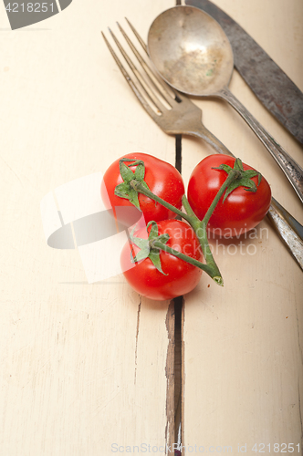 Image of ripe cherry tomatoes over white wood