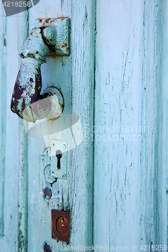 Image of spain  hand brass knocker abstract door in the grey