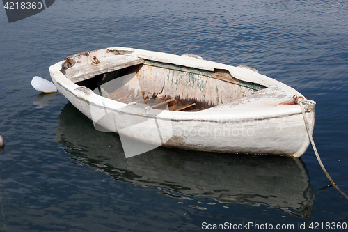 Image of A wooden rowing boat tide down