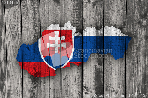 Image of Map and flag of Slovakia on weathered wood