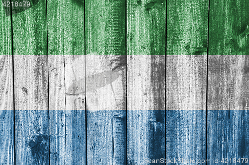 Image of Flag of Sierra Leone on weathered wood
