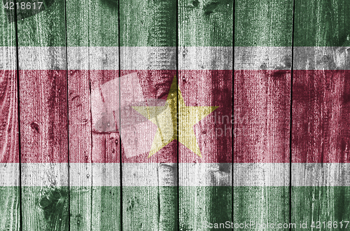 Image of Flag of Suriname on weathered wood