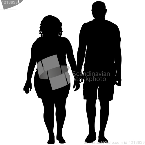 Image of Silhouette man and woman walking hand in hand