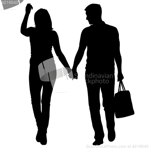 Image of Silhouette man and woman walking hand in hand