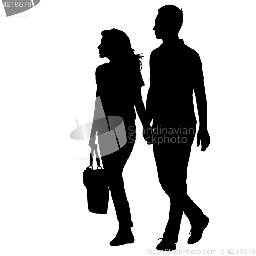 Image of Silhouette man and woman walking hand in hand