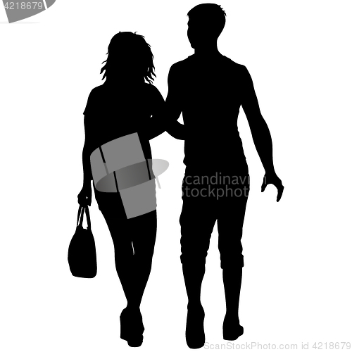 Image of Silhouette man and woman walking hand in hand