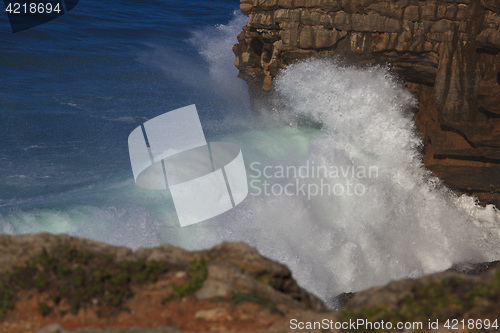 Image of Marine wave breaks against offshore stone