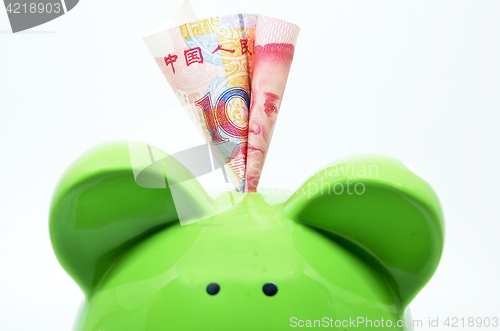 Image of Green piggy bank with China currency