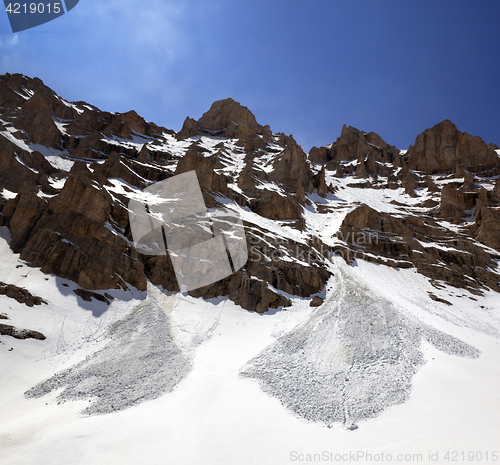 Image of Snowy rocks and trace from avalanche in spring