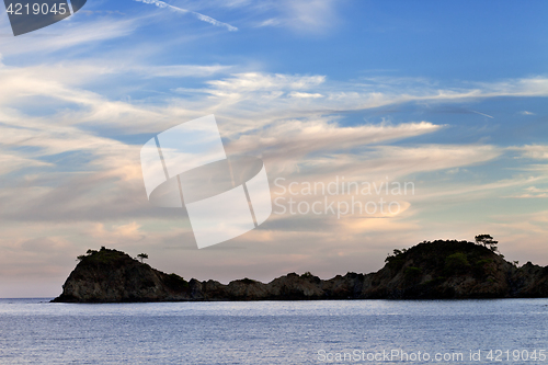 Image of Island in sea and beautiful sky with clouds at sunset