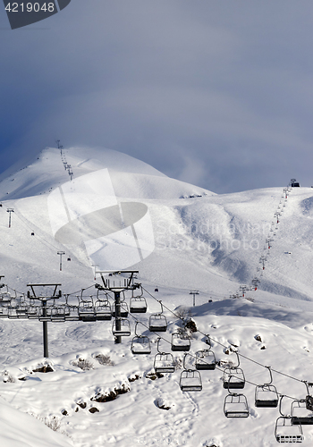 Image of Ski slope and ropeways in evening