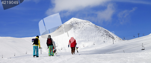 Image of Three snowboarder on slope at sun nice day