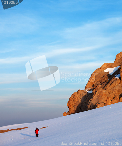 Image of Hiker at sunrise snow mountains