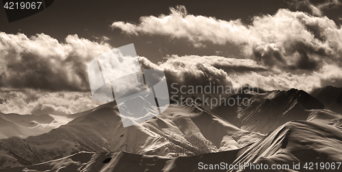 Image of Sepia evening mountains and sunlight clouds