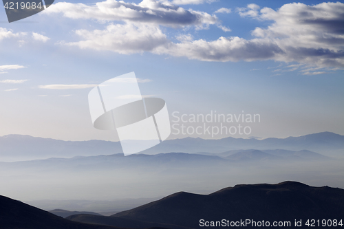 Image of Silhouette of mountains in fog at early morning
