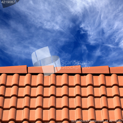 Image of Roof tiles and sky with clouds at sun day