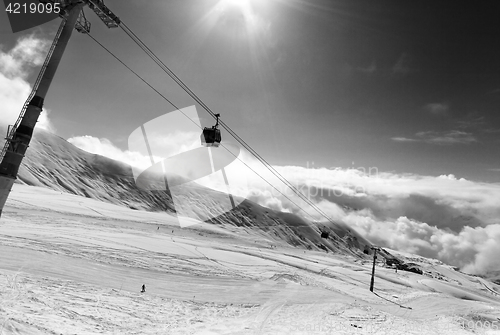 Image of Black and white view on gondola lift and ski slope at nice sunny