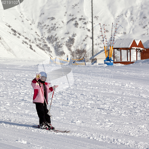 Image of Little skier at ski resort in sun winter day