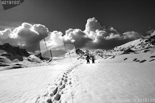 Image of Black and white view on snow plateau with hikers.