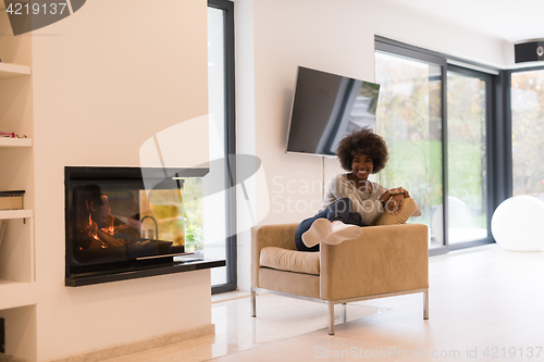 Image of black woman in front of fireplace