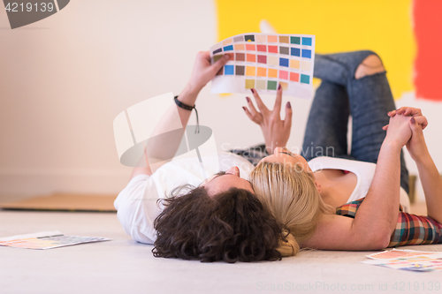 Image of Happy young couple relaxing after painting