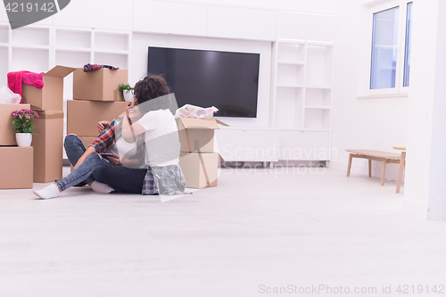 Image of young couple moving  in new house