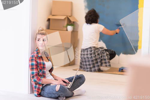 Image of Happy couple doing home renovations