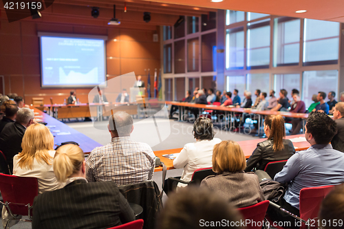 Image of Public speaker giving talk at business event.