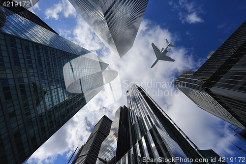 Image of Airplane in New York City Between Buildings