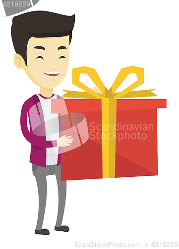 Image of Joyful asian man holding box with gift.