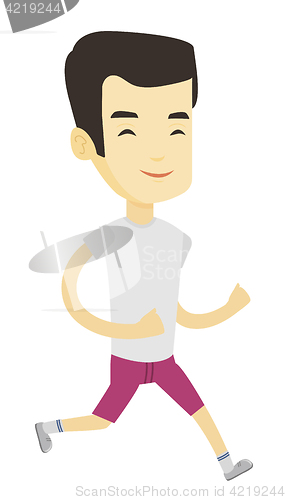 Image of Young sporty man jogging on the beach.