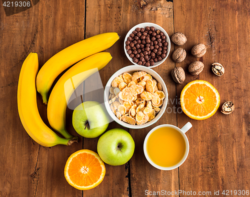 Image of Healthy home made breakfast of muesli, apples, fresh fruits and walnuts