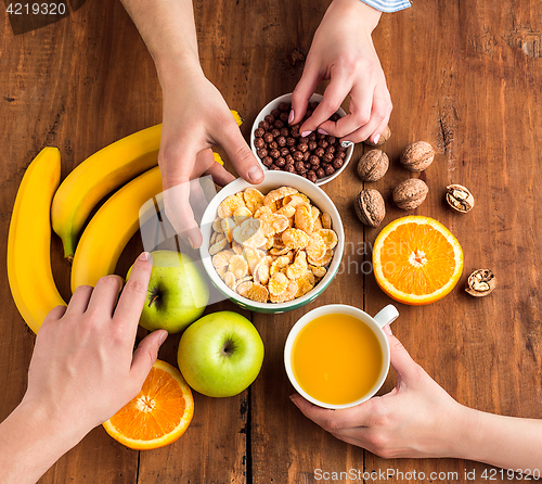 Image of Healthy home made breakfast of muesli, apples, fresh fruits and walnuts