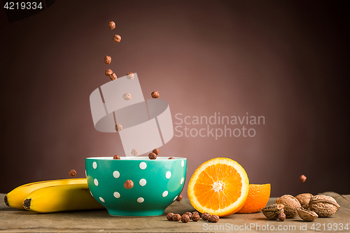 Image of Healthy home made breakfast of muesli, apples, fresh fruits and walnuts