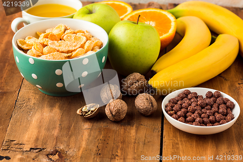 Image of Healthy home made breakfast of muesli, apples, fresh fruits and walnuts