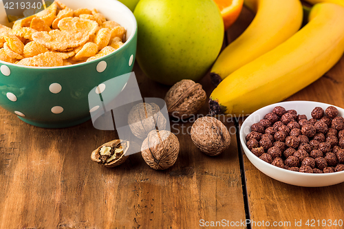 Image of Healthy home made breakfast of muesli, apples, fresh fruits and walnuts