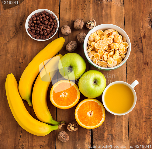 Image of Healthy home made breakfast of muesli, apples, fresh fruits and walnuts