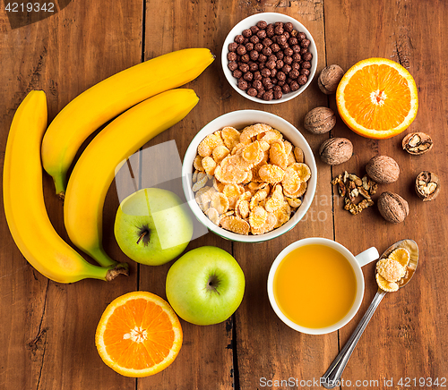 Image of Healthy home made breakfast of muesli, apples, fresh fruits and walnuts