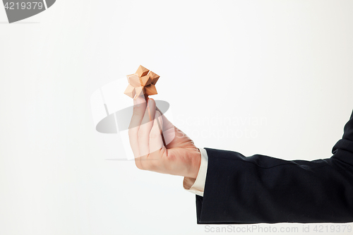 Image of Man\'s hands holding wooden puzzle.