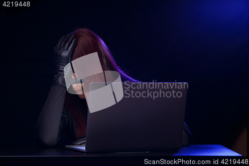 Image of Young girl hacker with laptop