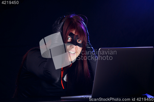 Image of Surprised brunette next to laptop