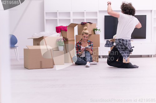 Image of young couple moving  in new house