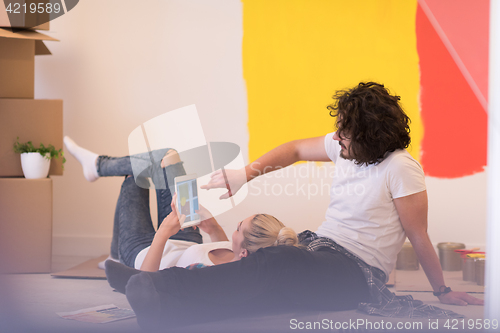 Image of Happy young couple relaxing after painting