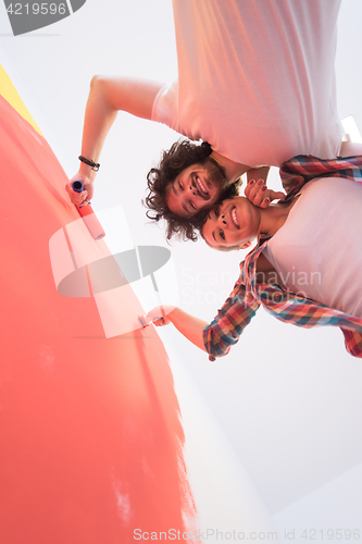 Image of couple painting interior wall